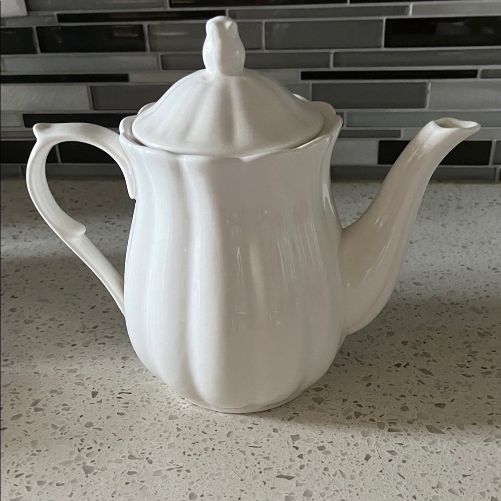 White Ceramic Teapot with Elegant Curved Spout and Lid